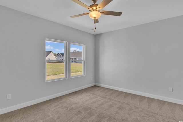 unfurnished room featuring baseboards, carpet, and a ceiling fan