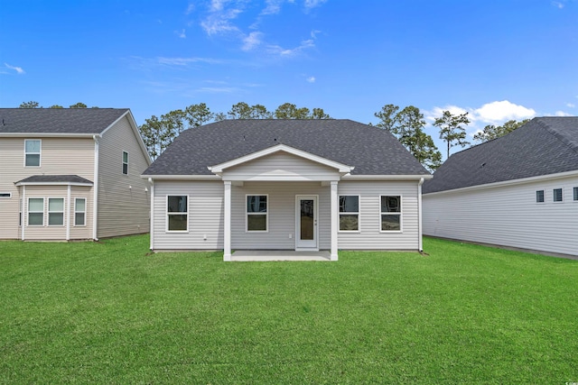 1200 NW Calabash Station Blvd, Calabash, NC 28467 - rear view of house with a patio, a shingled roof, and a yard