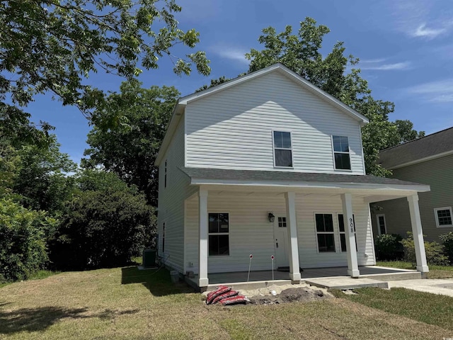 view of front facade featuring a front lawn, a porch, and central AC