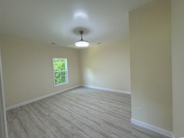 unfurnished room with light hardwood / wood-style flooring