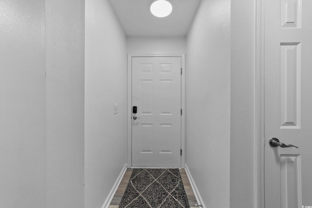 doorway to outside with wood-type flooring