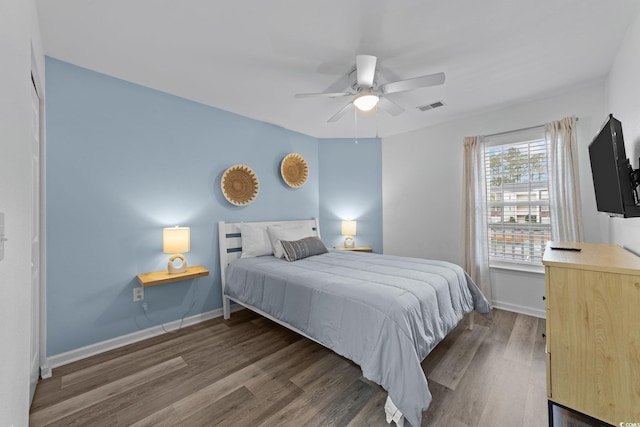 bedroom featuring ceiling fan and dark wood-type flooring