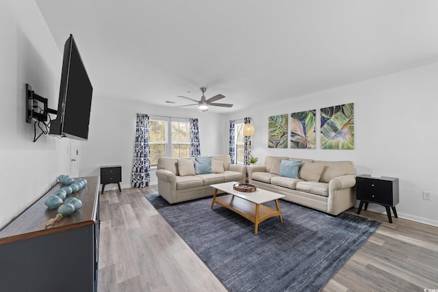 living room with hardwood / wood-style floors and ceiling fan