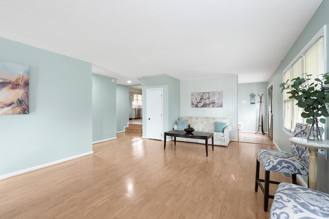 living room with plenty of natural light and light hardwood / wood-style floors