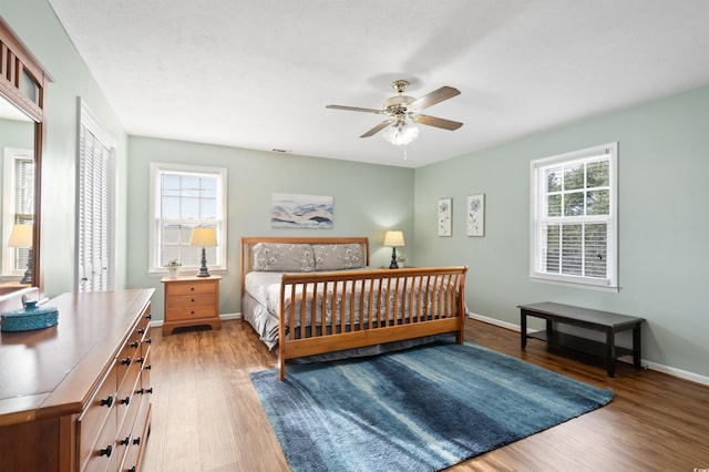 bedroom with ceiling fan, wood-type flooring, and a closet