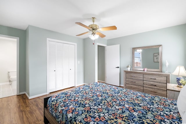 bedroom with ceiling fan, dark hardwood / wood-style flooring, ensuite bath, and a closet