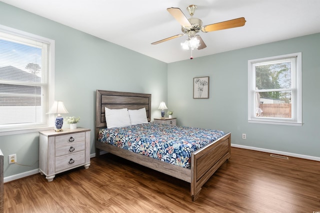 bedroom featuring ceiling fan and dark hardwood / wood-style floors