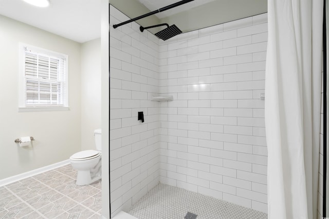 bathroom featuring toilet, tile patterned flooring, and walk in shower