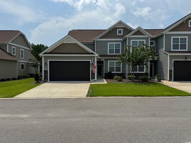 craftsman-style home with a front yard and a garage