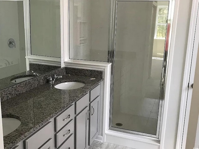 bathroom featuring vanity and an enclosed shower