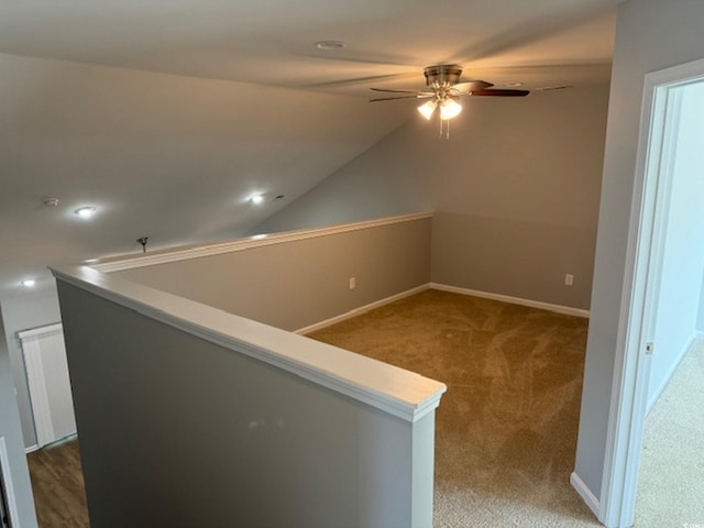 hall featuring lofted ceiling and carpet floors