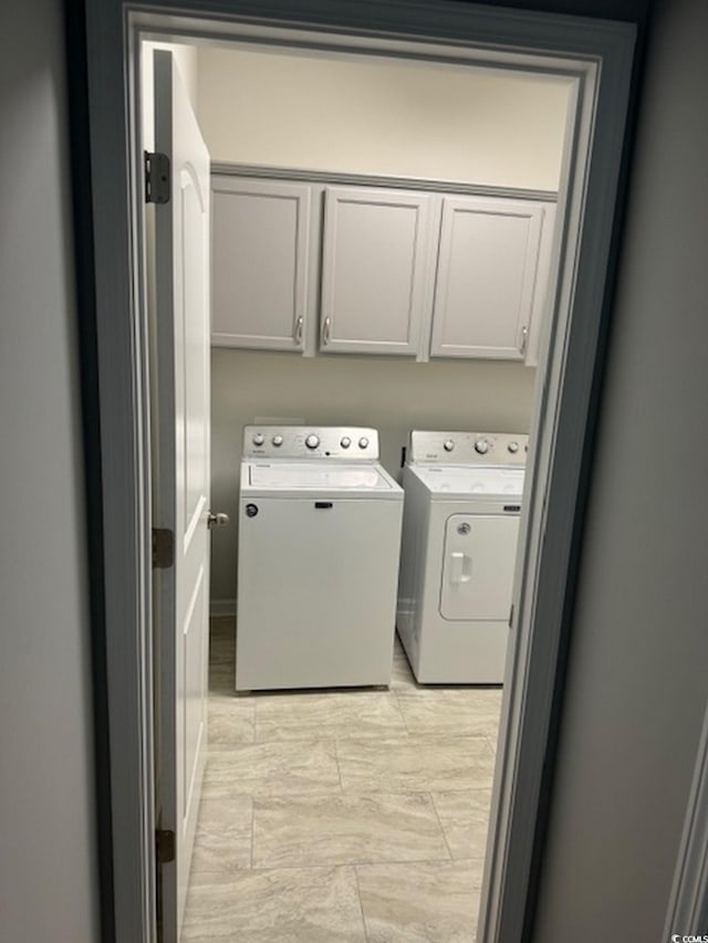 laundry room featuring cabinets and washer and dryer