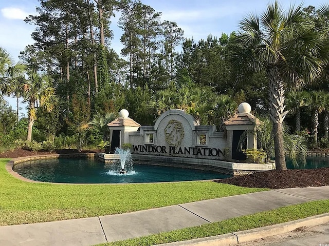 community sign featuring a lawn