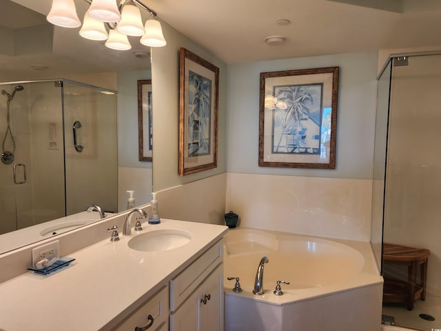 bathroom featuring shower with separate bathtub, vanity, and an inviting chandelier