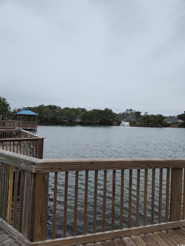 wooden terrace featuring a water view