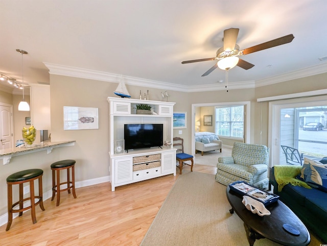 living room featuring ceiling fan, light hardwood / wood-style flooring, and ornamental molding