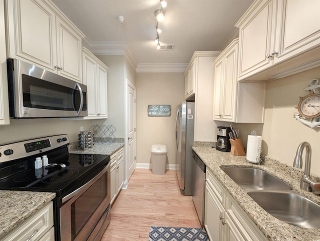 kitchen featuring sink, stainless steel appliances, light stone counters, light hardwood / wood-style floors, and ornamental molding