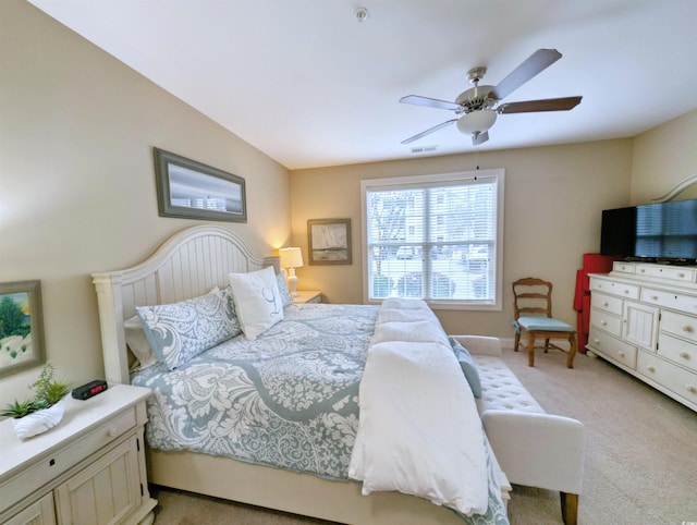 bedroom with ceiling fan and light colored carpet