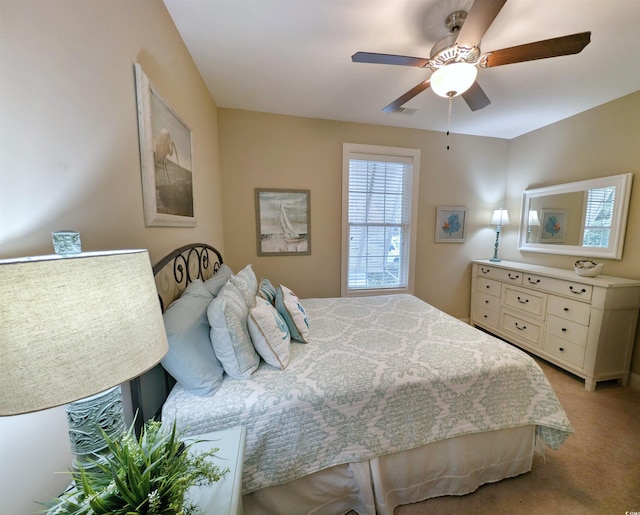 bedroom with ceiling fan and light carpet