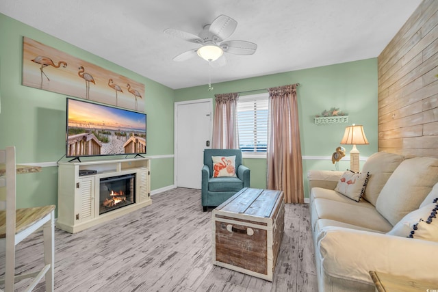 living room featuring ceiling fan and light wood-type flooring