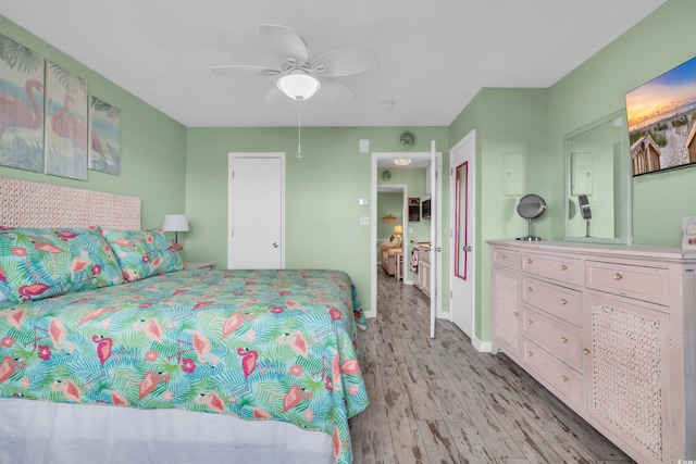 bedroom with ceiling fan and light hardwood / wood-style floors