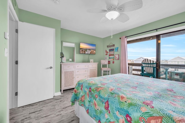 bedroom featuring access to exterior, light hardwood / wood-style flooring, and ceiling fan