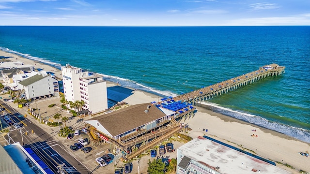 birds eye view of property featuring a water view and a beach view