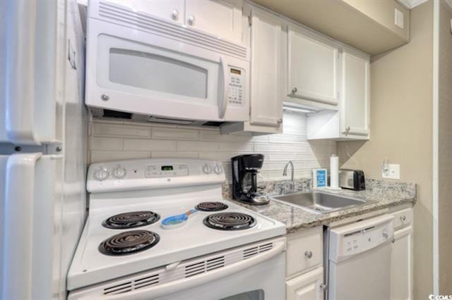 kitchen featuring white cabinets, white appliances, tasteful backsplash, and sink