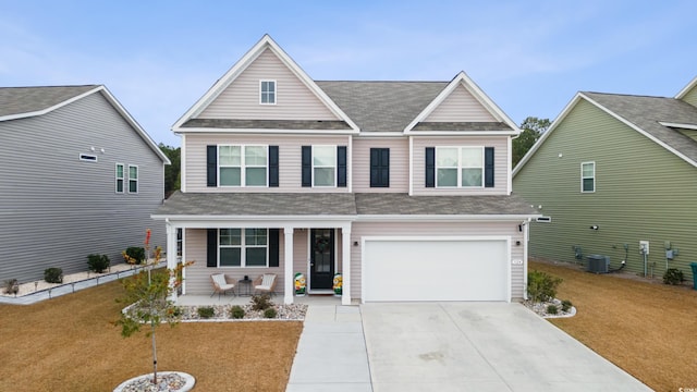 view of front facade featuring central AC unit, a garage, covered porch, and a front lawn