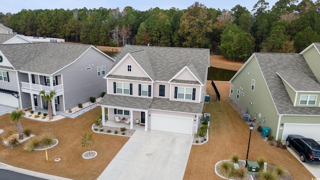 view of front of property with central AC and a garage