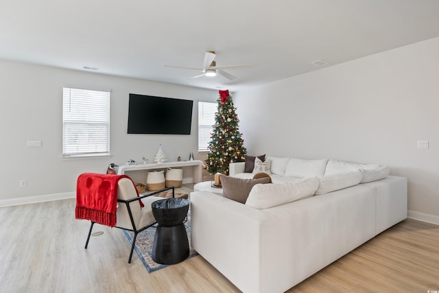 living room featuring light hardwood / wood-style floors and ceiling fan