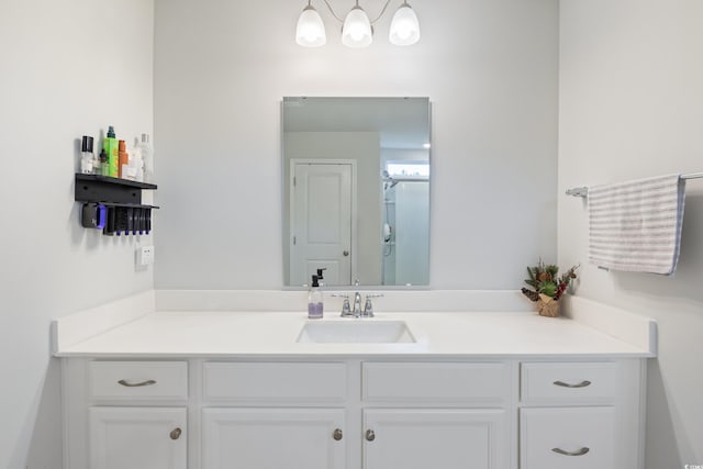 bathroom featuring vanity and a shower with shower door