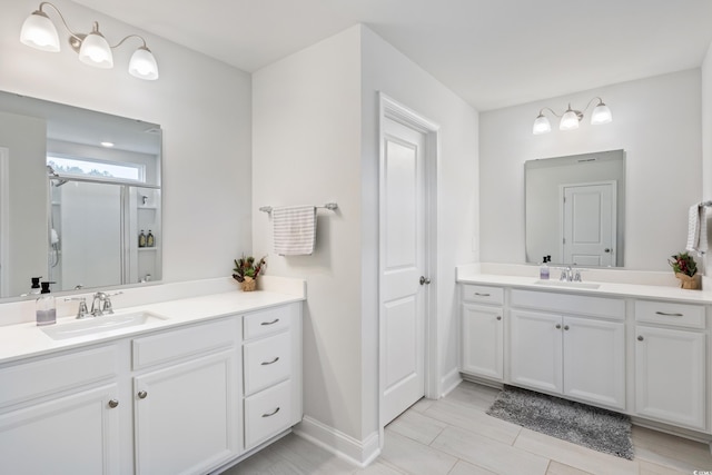 bathroom with vanity and a shower with shower door