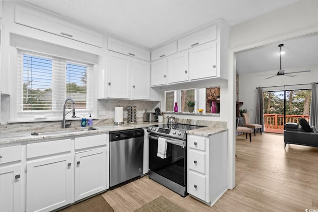 kitchen featuring white cabinetry, a healthy amount of sunlight, sink, and stainless steel appliances