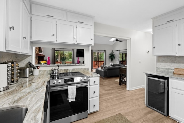 kitchen featuring white cabinetry, wine cooler, stainless steel range with electric stovetop, and ceiling fan