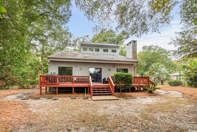 rear view of property with a wooden deck