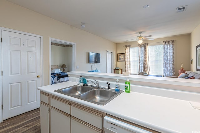 kitchen with a sink, open floor plan, light countertops, dark wood-style flooring, and visible vents