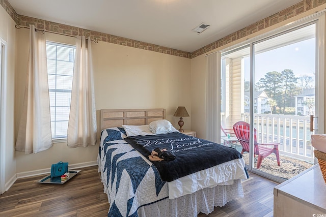1310 River Oaks Dr Unit 2J, Myrtle Beach, SC 29579 - bedroom featuring multiple windows, wood finished floors, and access to outside