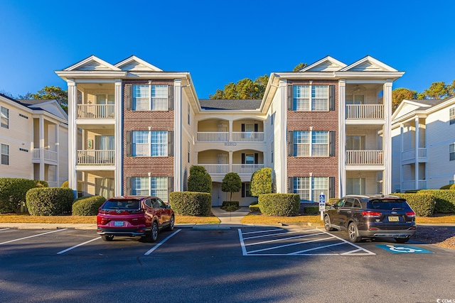 view of property featuring uncovered parking