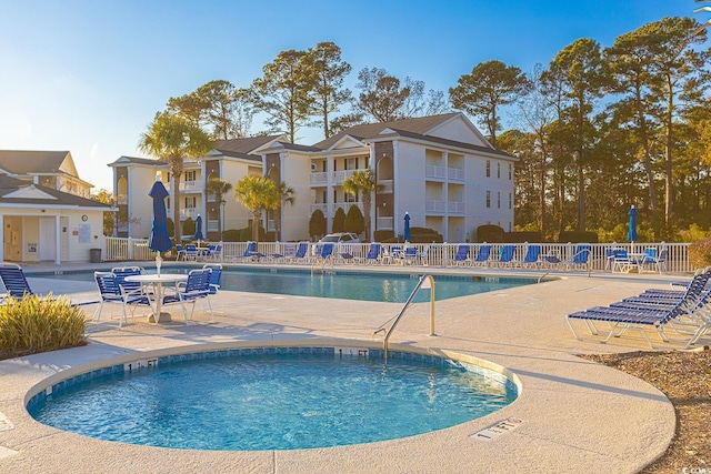 community pool featuring fence and a patio area