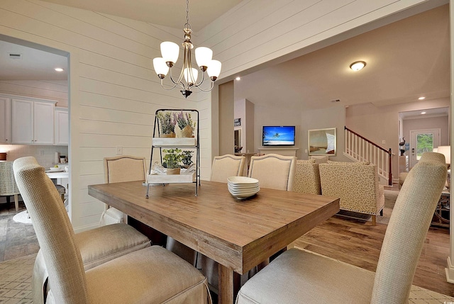 2038 Lone Cypress Dr, Myrtle Beach, SC 29579 - dining area featuring wooden walls, light hardwood / wood-style floors, lofted ceiling, and a notable chandelier