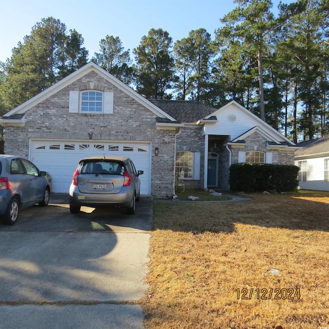 single story home with a front yard and a garage