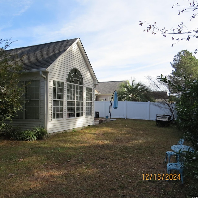 view of property exterior with a lawn