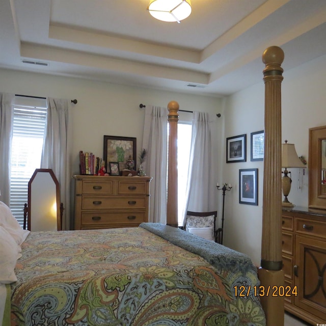 bedroom with a raised ceiling