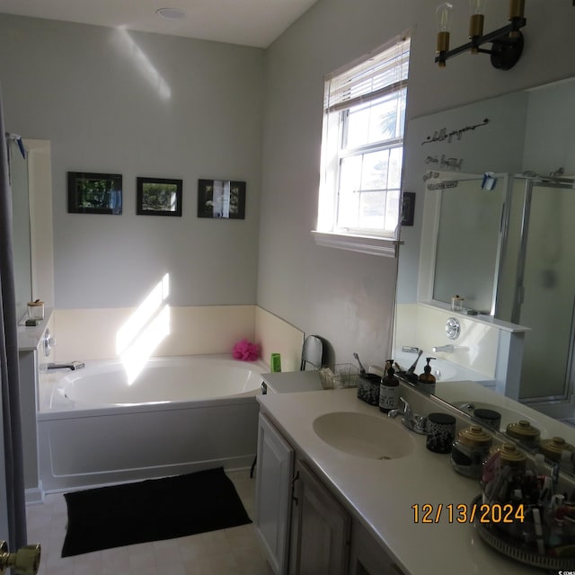 bathroom featuring shower with separate bathtub and vanity