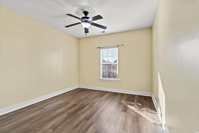 spare room featuring hardwood / wood-style floors and ceiling fan