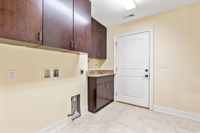 clothes washing area with sink, cabinets, washer hookup, electric dryer hookup, and light tile patterned floors