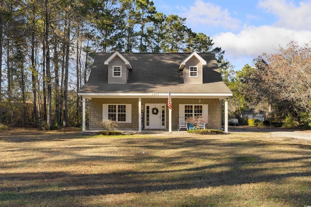 cape cod home with a front lawn and covered porch