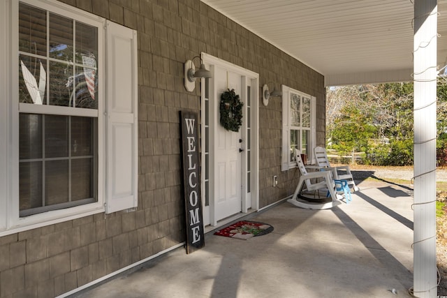 view of exterior entry with covered porch