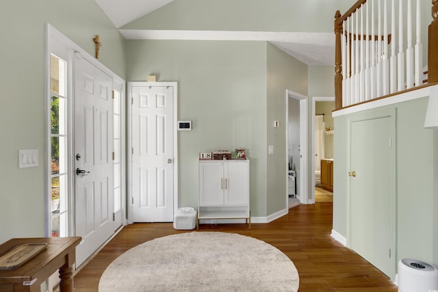 foyer entrance featuring vaulted ceiling and hardwood / wood-style flooring